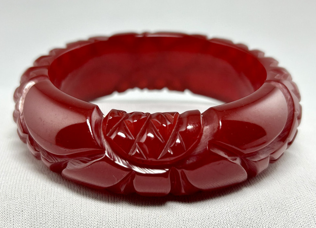 BB434 translucent cranberry flower carved bakelite bangle